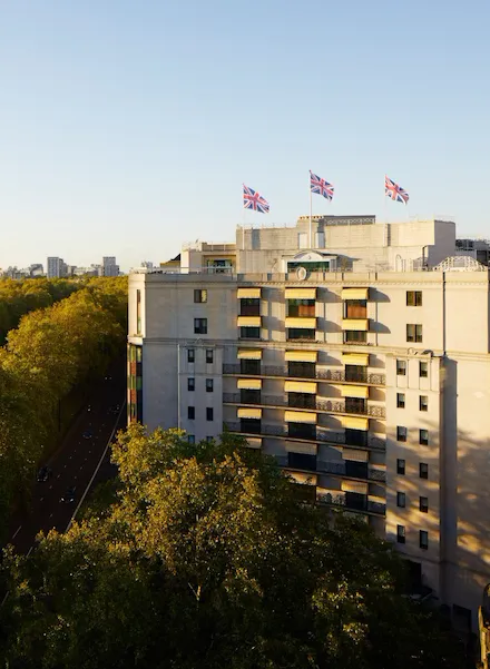 The Dorchester building exterior at sunset next to Hyde Park, London